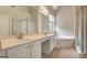 Bright bathroom with dual sinks, soaking tub, and glass-enclosed shower for a spa-like experience at 1619 Cascade Overlook, Peachtree City, GA 30269