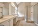 Bright bathroom with dual sinks, soaking tub, and glass-enclosed shower for a spa-like experience at 1619 Cascade Overlook, Peachtree City, GA 30269