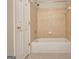 Bathroom featuring a white bathtub with tile surround at 1619 Cascade Overlook, Peachtree City, GA 30269
