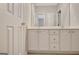 Bathroom featuring white double vanity with stylish faucets and hardware, and a large mirror at 1619 Cascade Overlook, Peachtree City, GA 30269