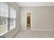 Bright bedroom features a large window with blinds and neutral carpeting at 1619 Cascade Overlook, Peachtree City, GA 30269