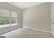 The bright bedroom offers comfortable carpet, a window, and neutral decor for a relaxing space at 1619 Cascade Overlook, Peachtree City, GA 30269