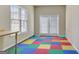 The bonus room is filled with natural light and features a whimsical, colorful floor at 1619 Cascade Overlook, Peachtree City, GA 30269
