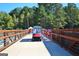 View of the Lake Peachtree bridge showing a golf cart and pedestrians at 1619 Cascade Overlook, Peachtree City, GA 30269