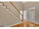 Entryway featuring wooden staircase and hardwood flooring leading to a glass panel door at 1619 Cascade Overlook, Peachtree City, GA 30269
