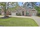 Elegant brick home with a manicured lawn and a spacious driveway leading to an attached garage at 1619 Cascade Overlook, Peachtree City, GA 30269
