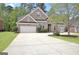 Traditional brick home featuring a spacious driveway, attached garage, and neatly landscaped front yard at 1619 Cascade Overlook, Peachtree City, GA 30269