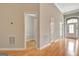 Bright hallway leading to a half bathroom and the front entry of this beautifully designed home at 1619 Cascade Overlook, Peachtree City, GA 30269