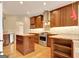 Kitchen featuring wooden cabinets, stainless steel appliances and a central island at 1619 Cascade Overlook, Peachtree City, GA 30269