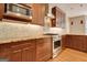 Close up of the kitchen with granite countertops, tile backsplash and stainless steel appliances at 1619 Cascade Overlook, Peachtree City, GA 30269