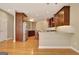 Open kitchen boasts stainless appliances, rich wood cabinetry, and an island for extra prep space and storage at 1619 Cascade Overlook, Peachtree City, GA 30269