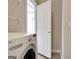Bright laundry room featuring a modern washing machine and convenient access to outdoor area through a white door at 1619 Cascade Overlook, Peachtree City, GA 30269