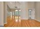 Bright living room with hardwood floors, a ceiling fan, and staircase, offering ample space at 1619 Cascade Overlook, Peachtree City, GA 30269