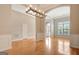 Spacious living room with hardwood floors, crown molding, and natural light from large windows at 1619 Cascade Overlook, Peachtree City, GA 30269