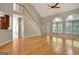 Bright living room with hardwood floors, staircase, and large arched windows, creating a warm atmosphere at 1619 Cascade Overlook, Peachtree City, GA 30269