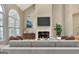 Cozy living room featuring fireplace, mounted TV, hardwood flooring and modern furniture accents at 1619 Cascade Overlook, Peachtree City, GA 30269