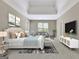 Cozy main bedroom with sitting area, tray ceiling, and TV at 1619 Cascade Overlook, Peachtree City, GA 30269