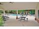Community pool featuring picnic tables, chairs and lounges in the covered structure at 1619 Cascade Overlook, Peachtree City, GA 30269