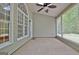 Covered porch with ceiling fan, large windows, and backyard views at 1619 Cascade Overlook, Peachtree City, GA 30269