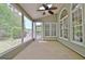 Covered porch with ceiling fan and multiple windows overlooking yard at 1619 Cascade Overlook, Peachtree City, GA 30269