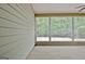Enclosed porch with ceiling fan and large windows overlooking backyard at 1619 Cascade Overlook, Peachtree City, GA 30269