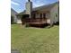 Charming backyard featuring a well-maintained wooden deck and a lush green lawn at 12214 Cypress Way, Fayetteville, GA 30215