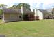 Well-maintained backyard featuring a wooden deck and mature lawn at 12214 Cypress Way, Fayetteville, GA 30215