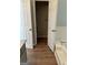 Bathroom doorway showing access to toilet, tub, and vanity, with wood flooring throughout at 12214 Cypress Way, Fayetteville, GA 30215