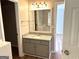 Bathroom featuring a vanity with granite countertop, framed mirror, and modern lighting at 12214 Cypress Way, Fayetteville, GA 30215