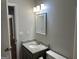 Bright bathroom featuring a vanity with granite countertop and modern fixtures at 12214 Cypress Way, Fayetteville, GA 30215