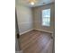 Bedroom featuring ceiling fan, hardwood floors and a window at 12214 Cypress Way, Fayetteville, GA 30215
