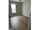 Bedroom featuring hardwood floors and a window at 12214 Cypress Way, Fayetteville, GA 30215