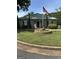 Community building with tidy landscaping, including a decorative flower bed and an American flag at 12214 Cypress Way, Fayetteville, GA 30215