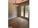 Bright dining area featuring a modern chandelier and glass doors to deck at 12214 Cypress Way, Fayetteville, GA 30215