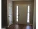 Bright foyer with hardwood floors and a white front door with sidelights at 12214 Cypress Way, Fayetteville, GA 30215