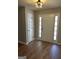 Welcoming foyer featuring hardwood floors and a white front door with sidelights at 12214 Cypress Way, Fayetteville, GA 30215