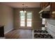 View of kitchen and adjacent dining area with access to outdoor space at 12214 Cypress Way, Fayetteville, GA 30215