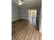 Open-concept living room with hardwood floors, neutral walls, and bright foyer at 12214 Cypress Way, Fayetteville, GA 30215