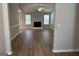 Spacious living room featuring a fireplace, hardwood floors, and bright windows at 12214 Cypress Way, Fayetteville, GA 30215