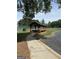 Shaded wooden pavilion near a walkway and tennis court, ideal for relaxing and socializing at 12214 Cypress Way, Fayetteville, GA 30215
