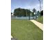 Outdoor pickleball court offers a recreational amenity, fenced for privacy, with visible benches and court rules posted at 12214 Cypress Way, Fayetteville, GA 30215