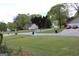 Pleasant street view with mature trees and well-kept lawns at 12214 Cypress Way, Fayetteville, GA 30215