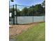 Fenced community tennis court with a well-maintained surface for recreational play at 12214 Cypress Way, Fayetteville, GA 30215