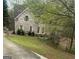 Charming two-story brick home featuring a well-manicured lawn and lush, mature landscaping at 4588 Carissa Ct, Ellenwood, GA 30294