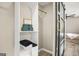 Walk in closet features a modern sliding door and white shelving with built in storage at 1766 Ware Ave, East Point, GA 30344