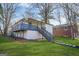 Backyard view of the house with a lush lawn and tall mature trees at 1766 Ware Ave, East Point, GA 30344