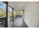 Covered porch with wood floors and railings and a view of the surrounding greenery at 1766 Ware Ave, East Point, GA 30344