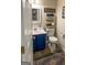 Charming half bathroom with a blue vanity and a decorative rug at 345 S Magnolia Se Walk, Atlanta, GA 30349