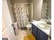 Functional bathroom featuring a shower-tub combo with a floral shower curtain at 345 S Magnolia Se Walk, Atlanta, GA 30349