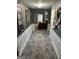 Inviting home hallway with wood floors and decorative wall art, leading to a bright living space at 345 S Magnolia Se Walk, Atlanta, GA 30349